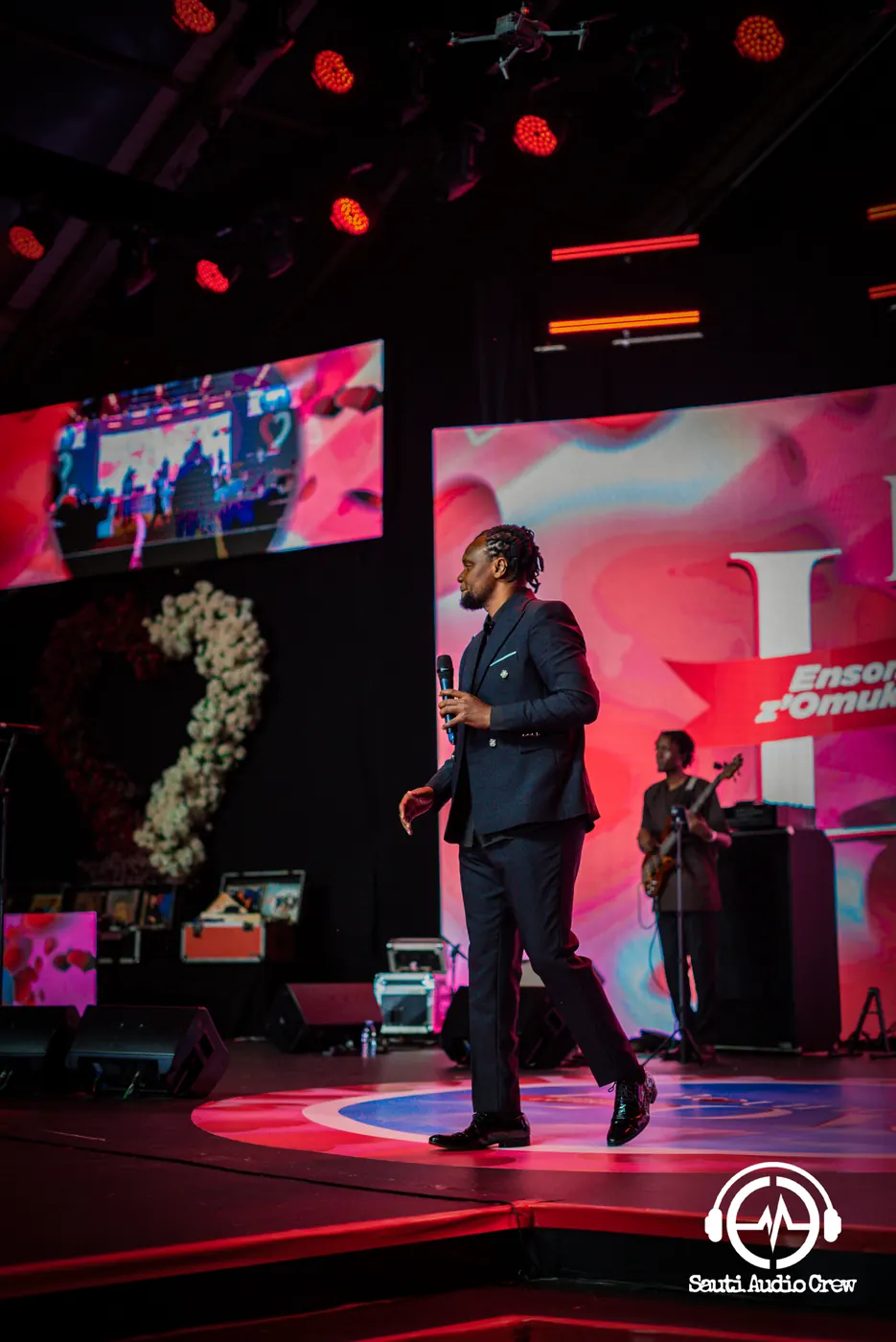 Host speaking on stage with a wireless microphone